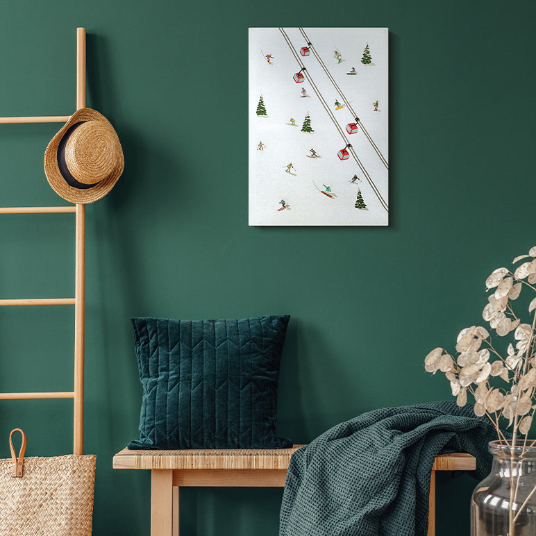 Nest living room with green wall, wooden bench, decorative pillow, and wall art.