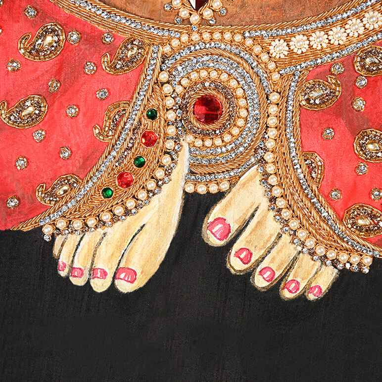 Close-up of a decorative garment with gold embroidery and red fabric