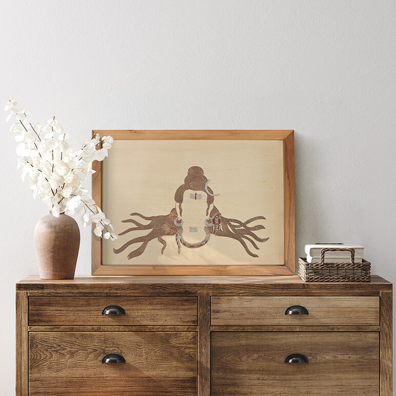 Wooden dresser with a framed picture, vase, and books against a light wall.