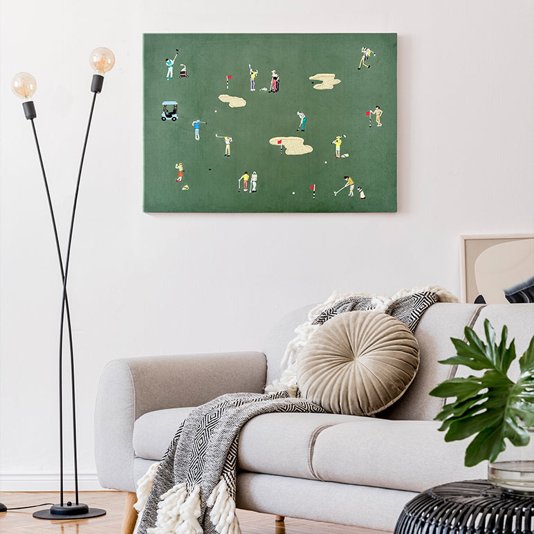 Living room with a green wall art piece depicting a golf scene, white sofa, and decorative lamp.