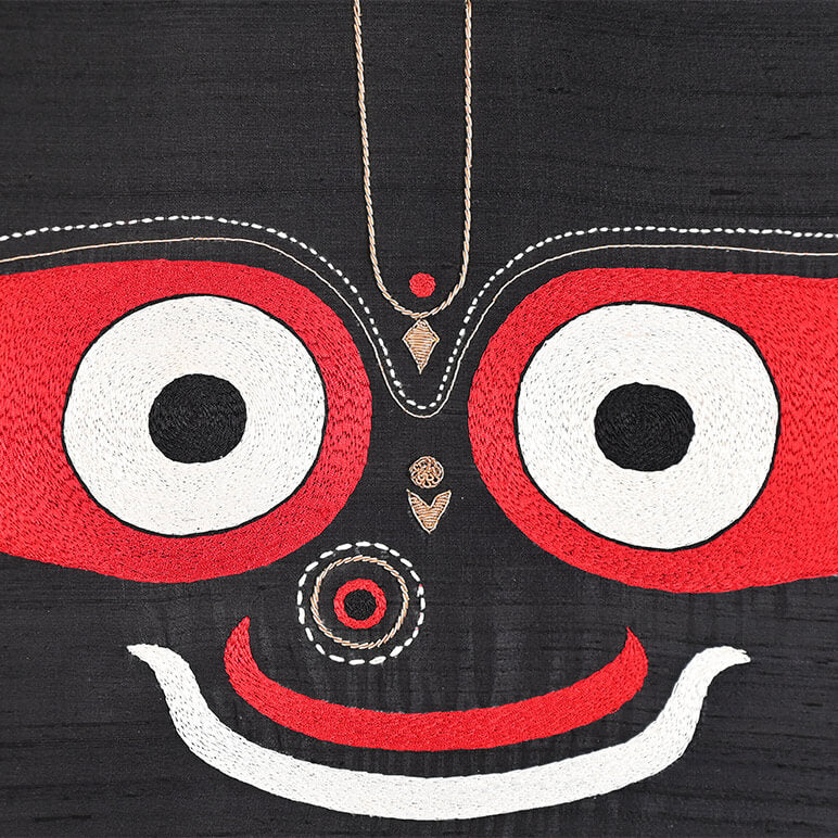 Black fabric with red and white embroidered face design