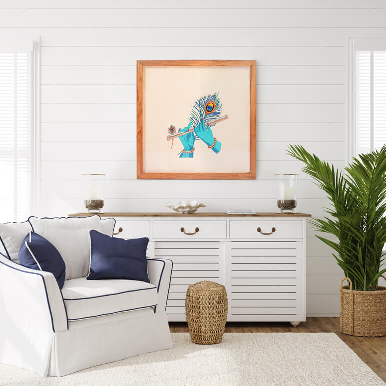 Living room with white walls, a white sofa with blue pillows, a wooden sideboard, and a framed artwork of a blue creature.