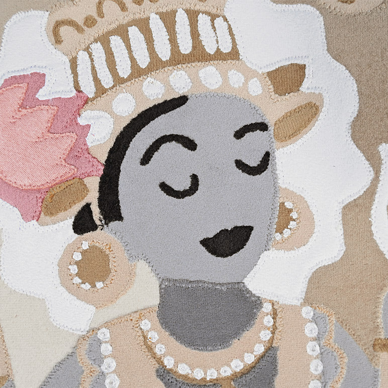 Decorative rug with artistic depiction of a face wearing a crown and pearl necklace on a patterned background.