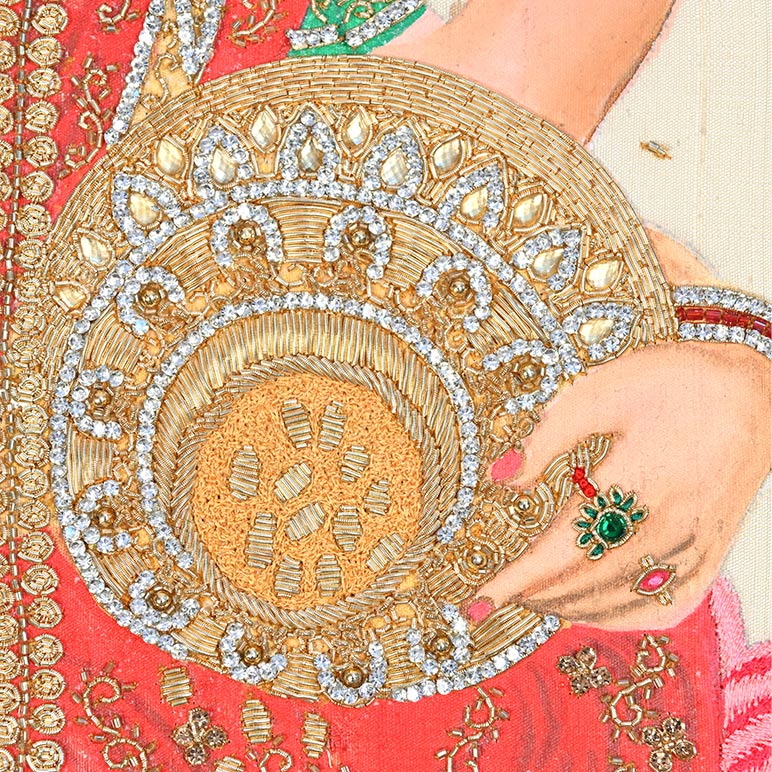 Close-up of a hand with jewelry on a red fabric background