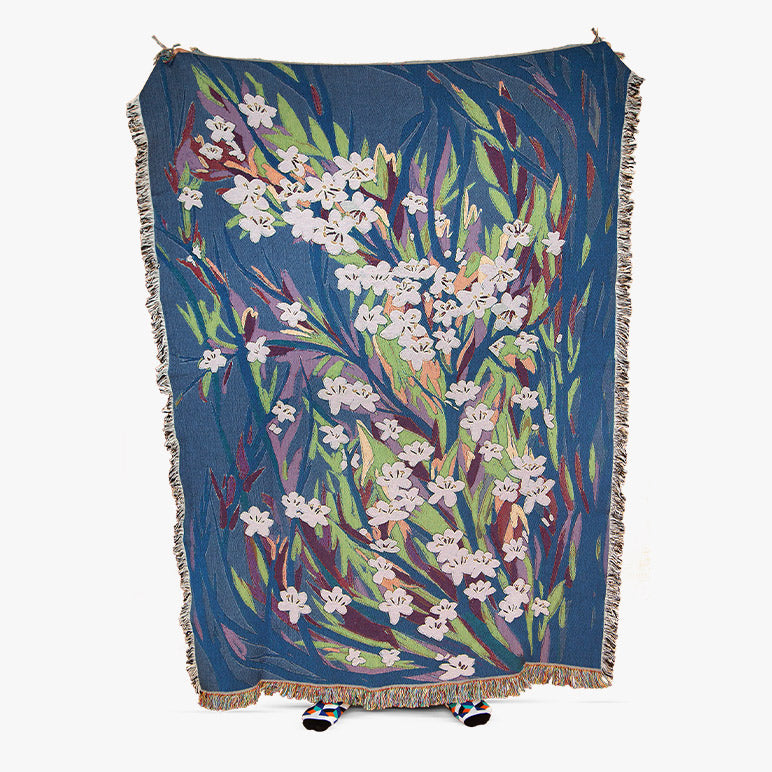 Floral patterned throw blanket on a white background