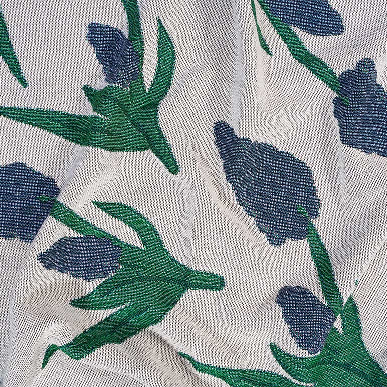 Close-up of fabric with blue floral pattern on a white background