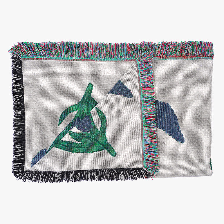 Throw blanket with woven design of blue Muscari flowers with green stems