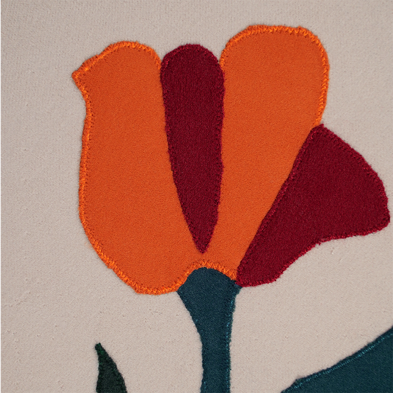 Close-up of a floral design with orange, red, and green colors on a beige background.