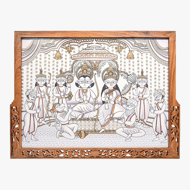 Decorative wall art with a wooden frame featuring an intricate design of seated figures and attendants.