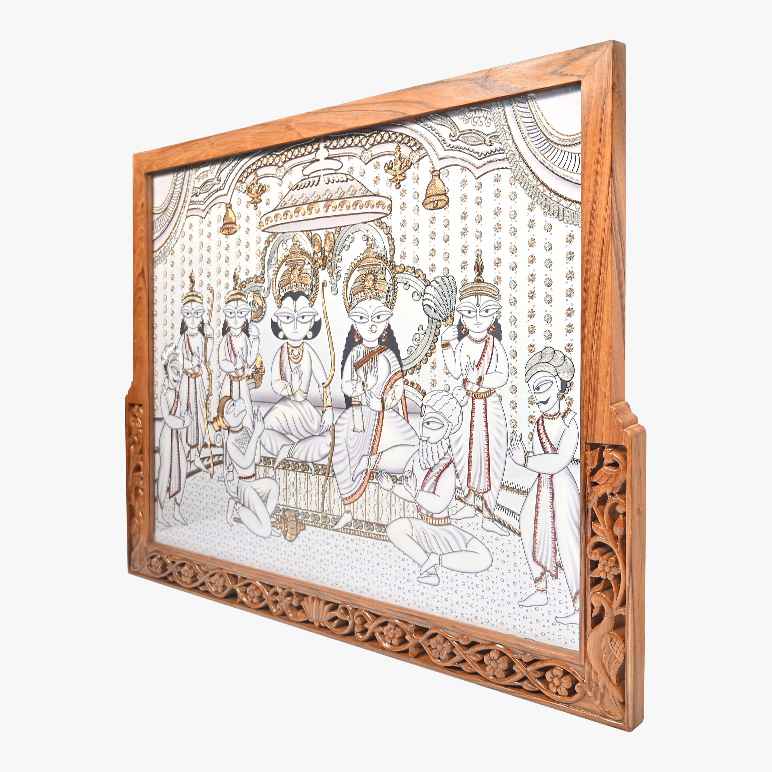 Decorative wall art with a wooden frame featuring an intricate design of seated figures on a white background.