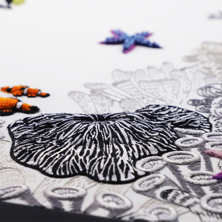 Close-up of a detailed embroidery project with a butterfly design.