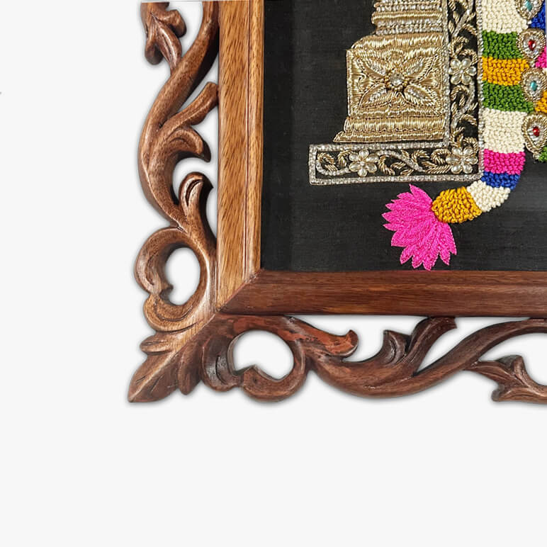 Decorative wooden frame with embroidered fabric featuring colorful patterns.