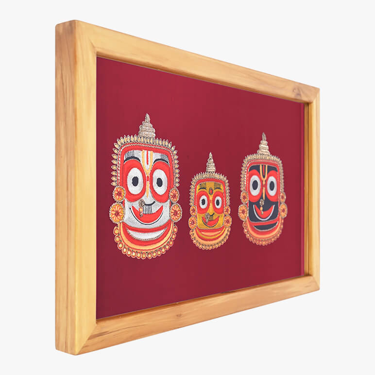 Framed artwork with three colorful masks on a red background