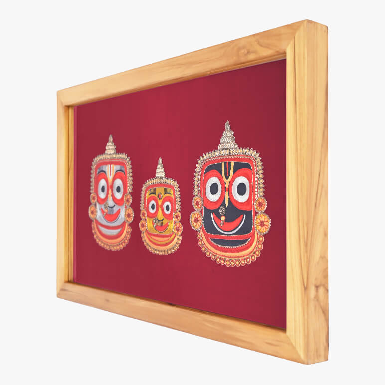 Framed artwork with three colorful masks on a red background