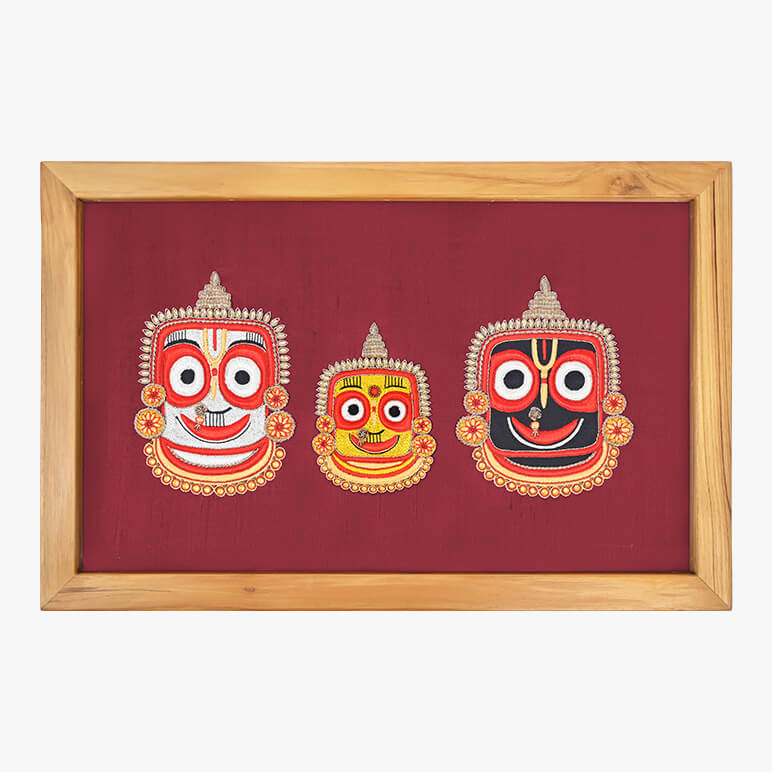 Decorative wall art with three colorful masks on a red background, framed in wood.