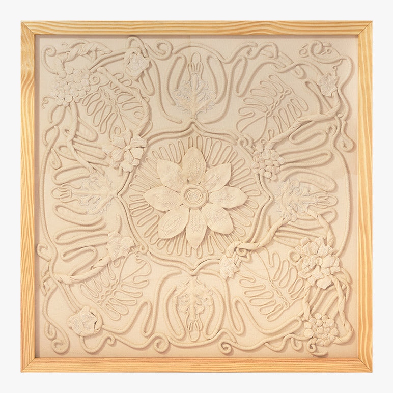 Decorative wall panel with floral and leaf patterns in a wooden frame.
