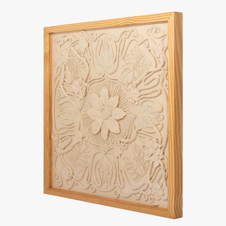 Decorative wall art with floral patterns in a wooden frame on a white background