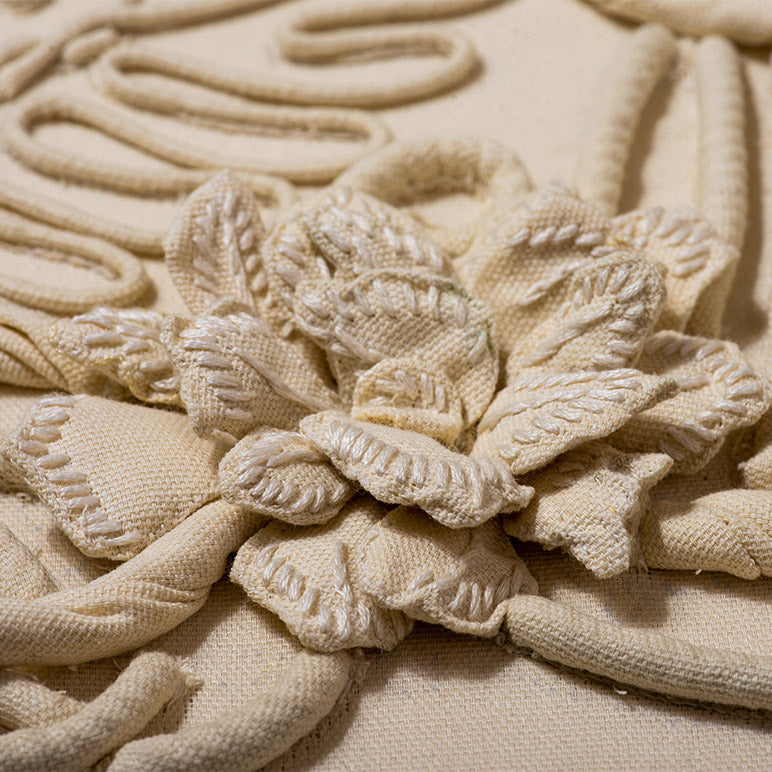 Close-up of textured beige fabric with floral design