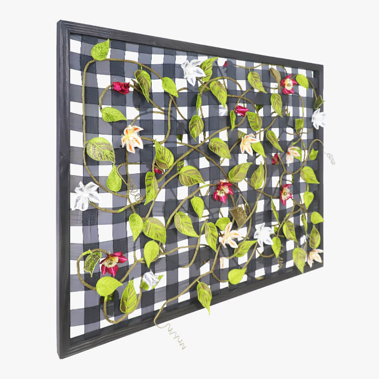 Decorative wall art with floral design on a checkered background
