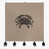 Embroidered wall hanging with a black crab motif on taupe fabric, finished with black-and-grey tassels along the bottom.