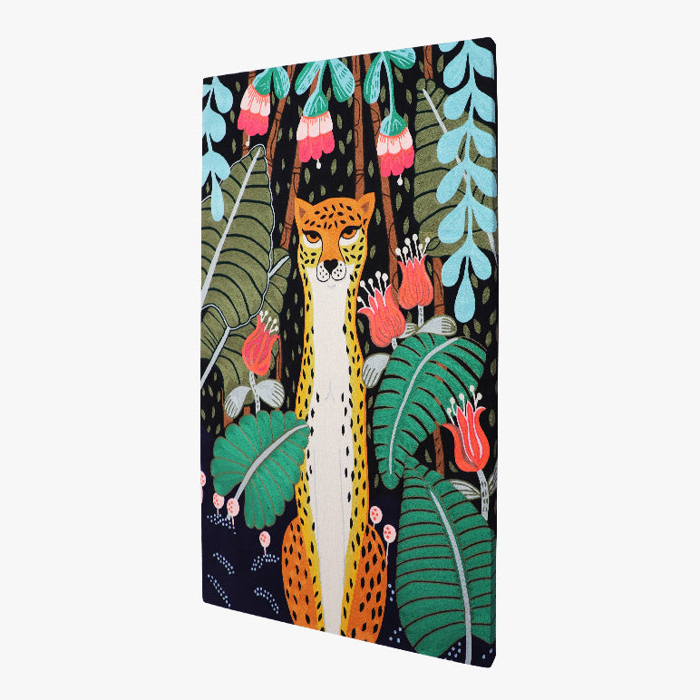 angled view of an embroidered wall art showcasing a cheetah sitting amidst tropical jungle foliage and flowers