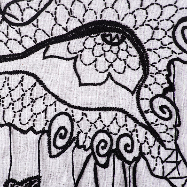 Close-up of black embroidery on white fabric