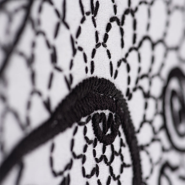 Close-up of a black headband with a patterned background