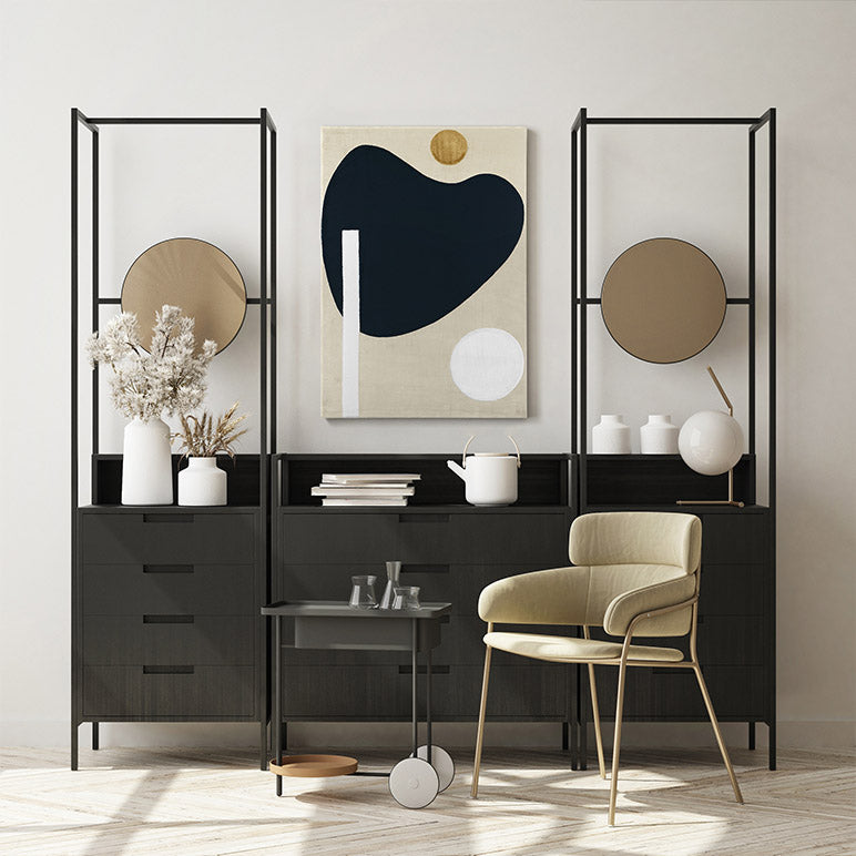Modern interior design with black room divider, abstract art, and beige chair.