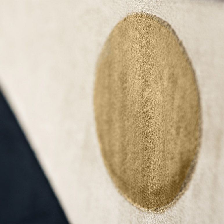 Close-up of a textured beige patch on a white background