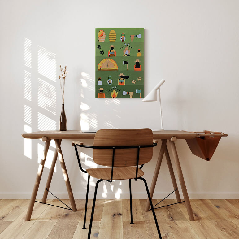 Wooden desk with chair and a colorful wall art piece in a room with wooden flooring.