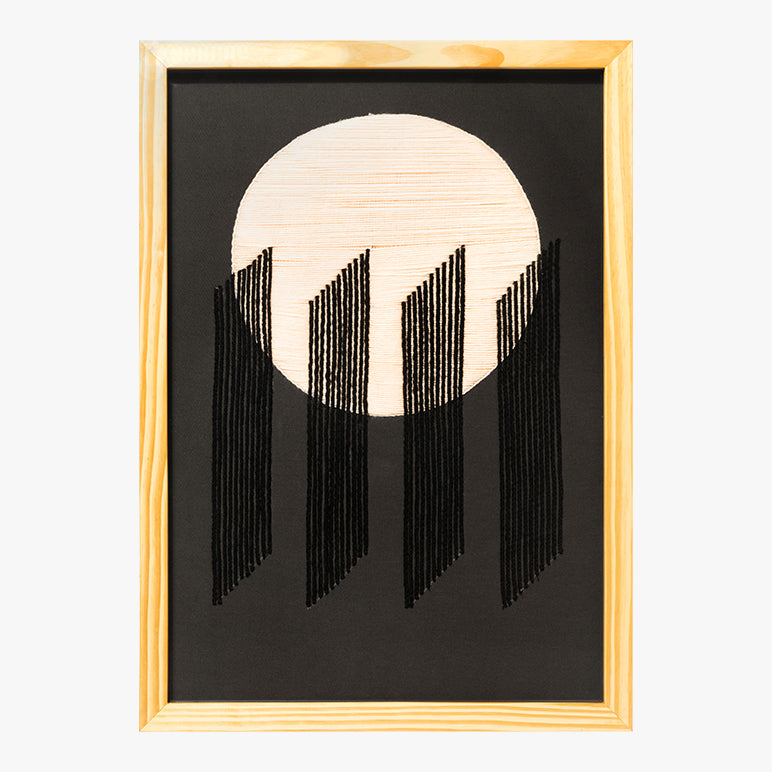 Framed artwork with a circular design and vertical lines on a black background