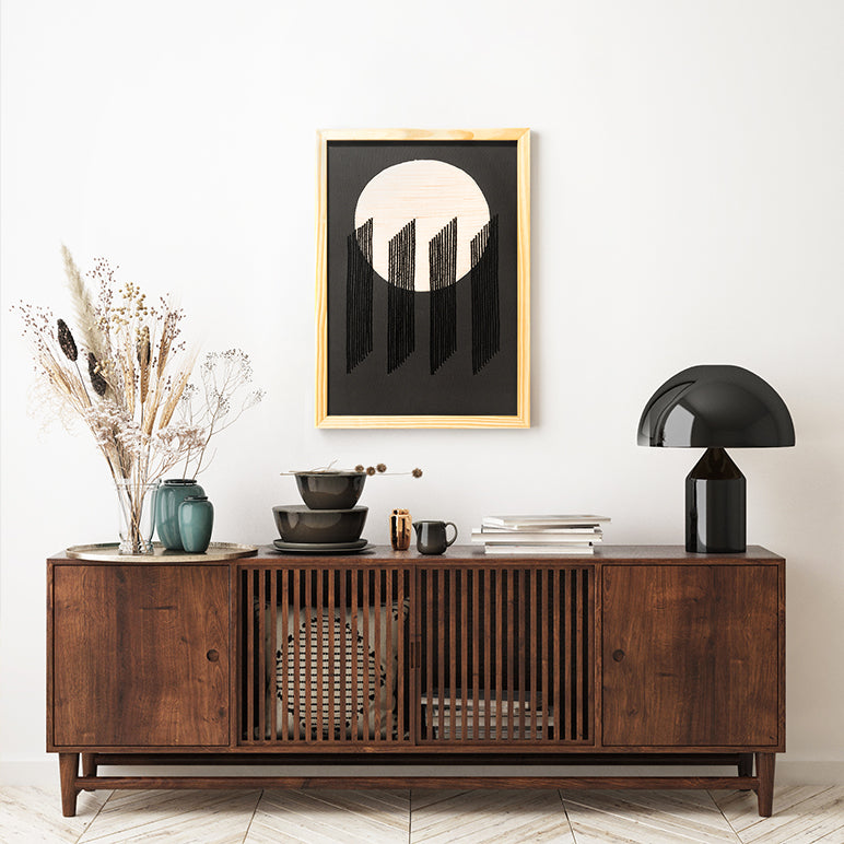 Wooden sideboard with decorative items against a white wall