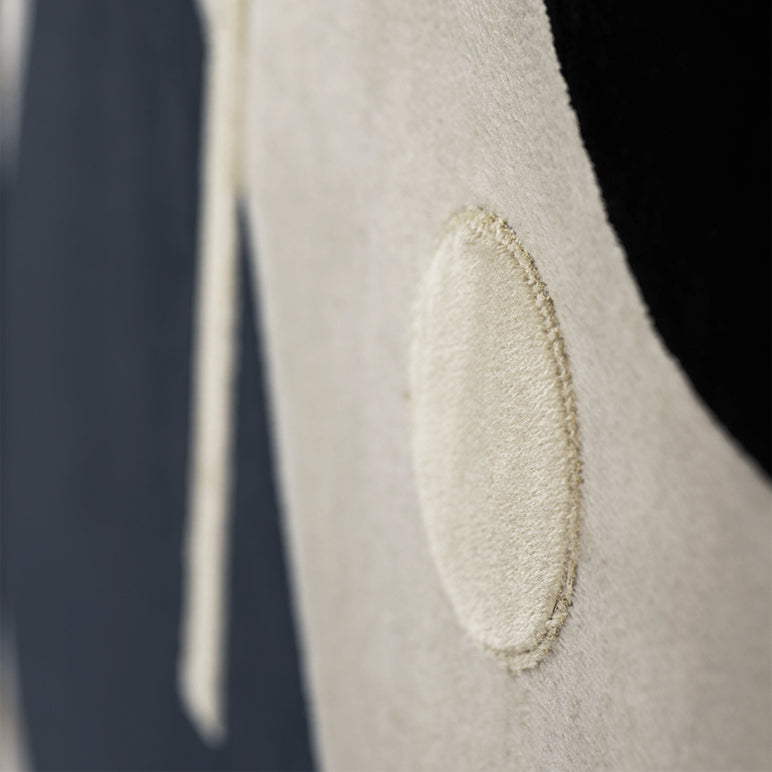 Close-up of a textured fabric surface with a small patch.