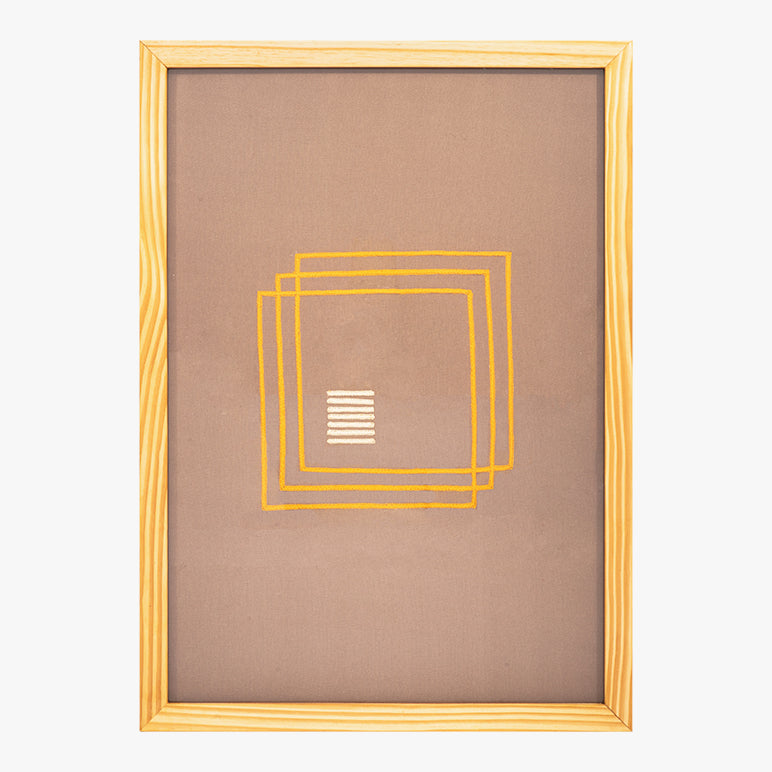 Framed artwork with geometric design on a plain background