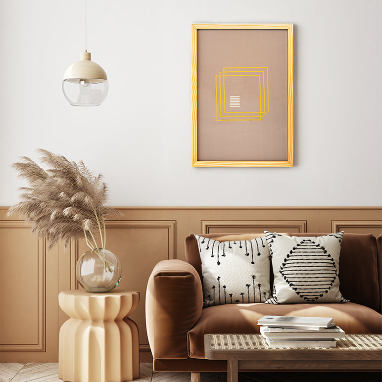 Modern living room with a brown sofa, decorative pillows, and a framed artwork on the wall.