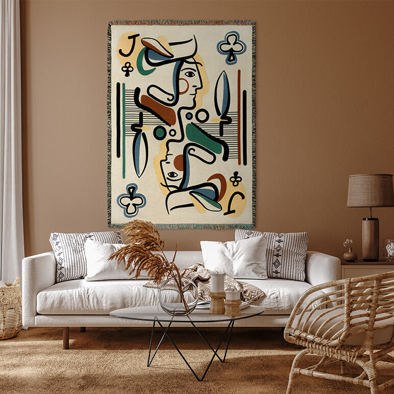 Abstract artwork hanging above a living room sofa with decorative elements.