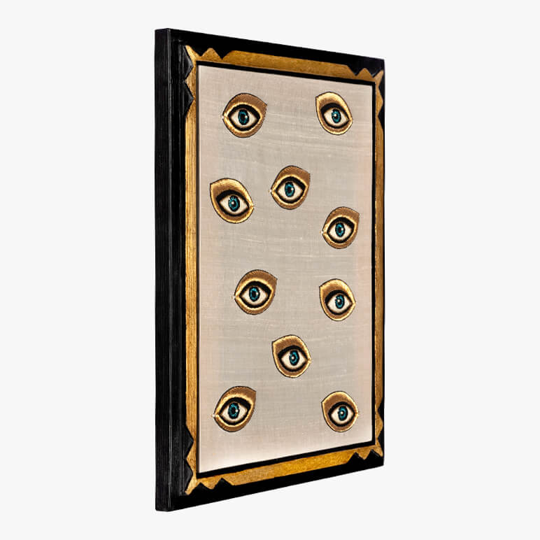 Decorative wall art with eyes on a beige background