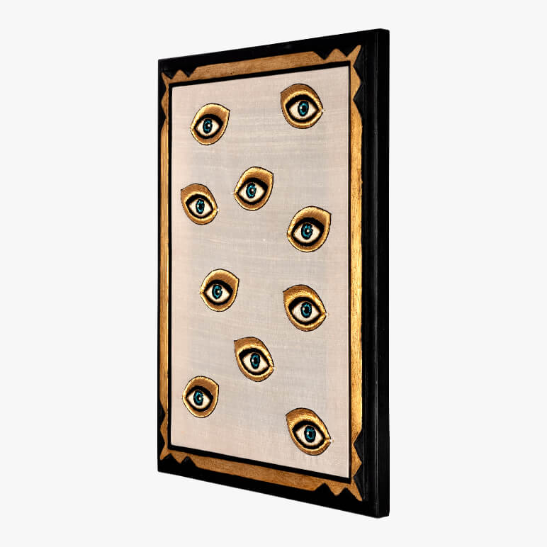 Decorative wall art with eye designs on a beige background