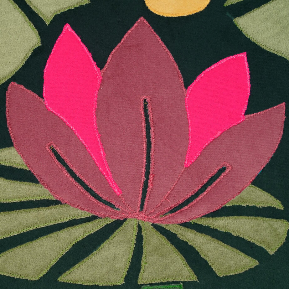 Close-up of a pink floral design on a dark background