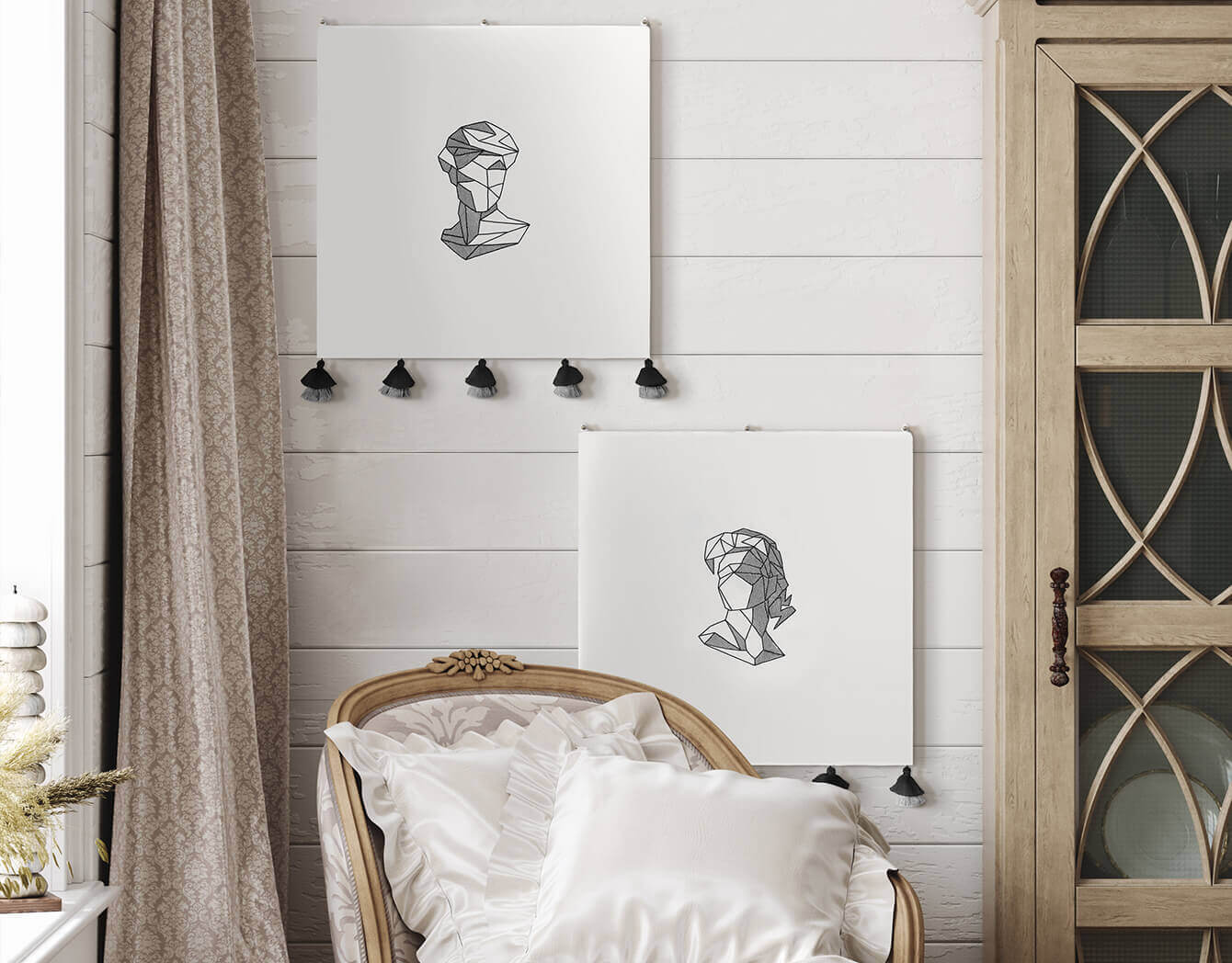 two abstract embroidered wall hangings seen in a modern white room