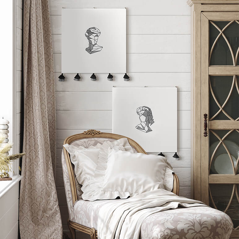 Decorative room with a chair, abstract embroidered artwork on the wall, and a cabinet.