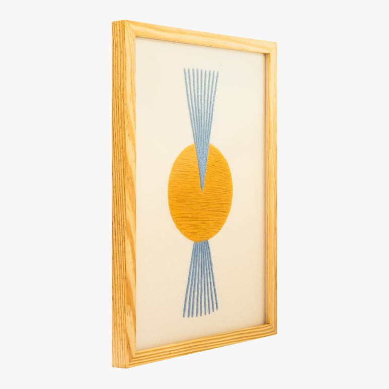 Framed abstract art with yellow circle and blue lines on a white background