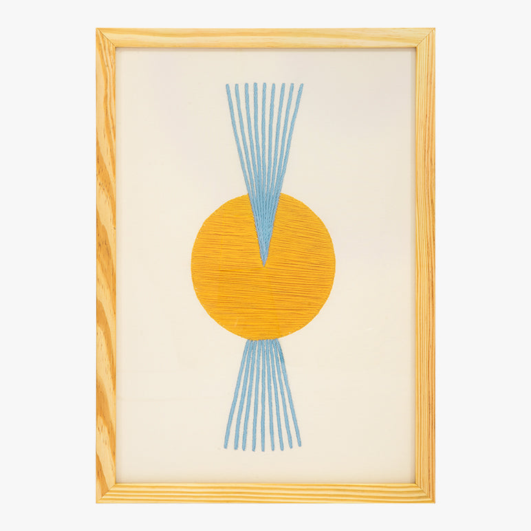 Framed abstract art with a yellow circle and blue lines on a beige background