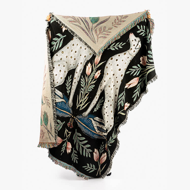 Decorative blanket with animal and floral pattern on a white background