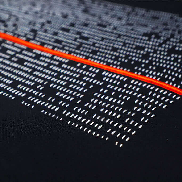 Close-up of a textured surface with red, white, and black patterns