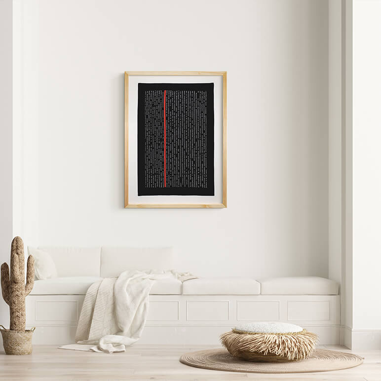 Framed artwork on a wall above a white sofa in a minimalistic living room.
