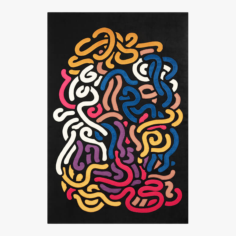 Colorful abstract textile wall art done in patchwork on a black fabric background