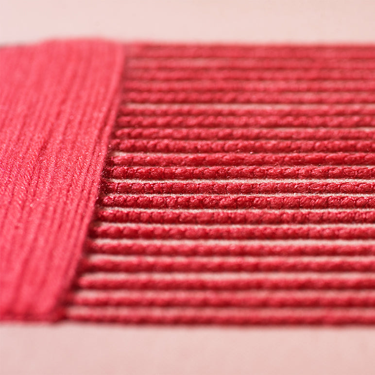 Close-up of pink textured fabric on a light pink background
