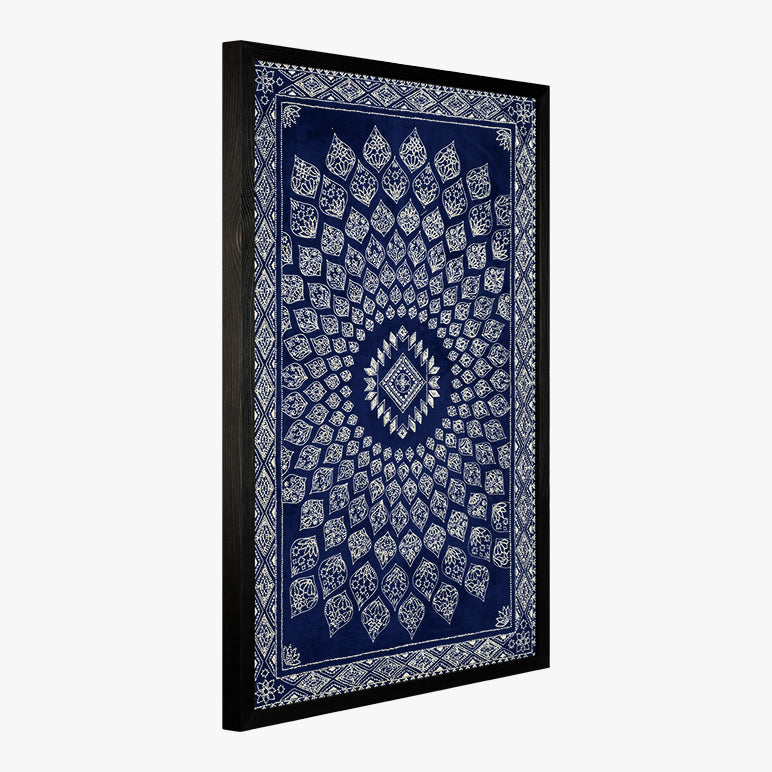 Decorative wall tapestry with blue and white pattern in a black frame on a white background