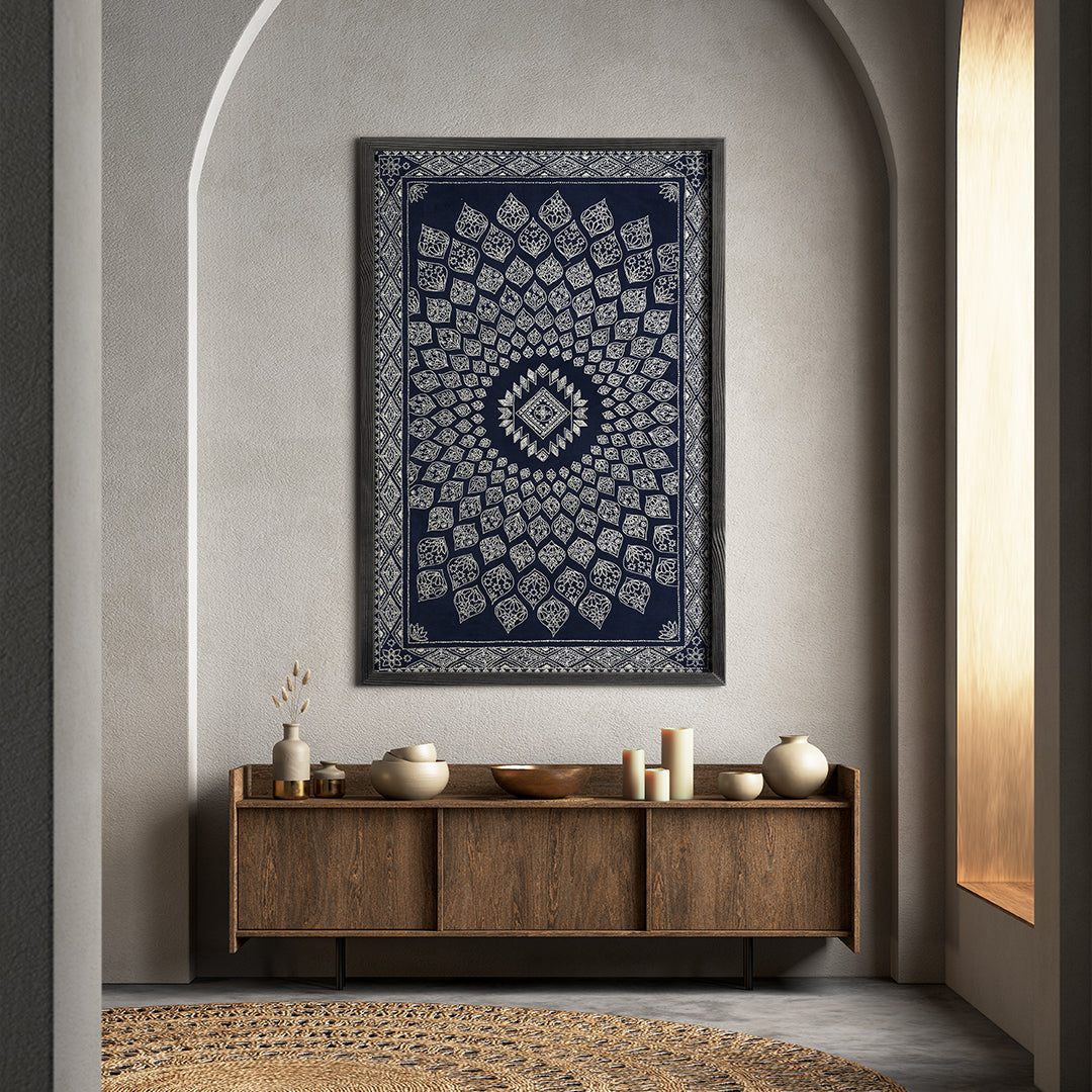Decorative wall tapestry with geometric pattern on a neutral wall above a wooden console table.